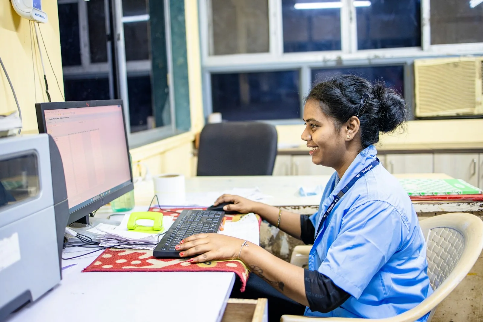 A clinician entering records at a workstation