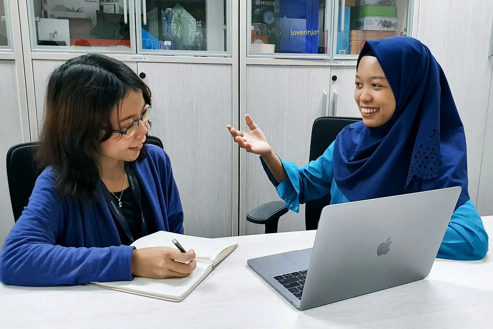 Two researchers working through a project together
